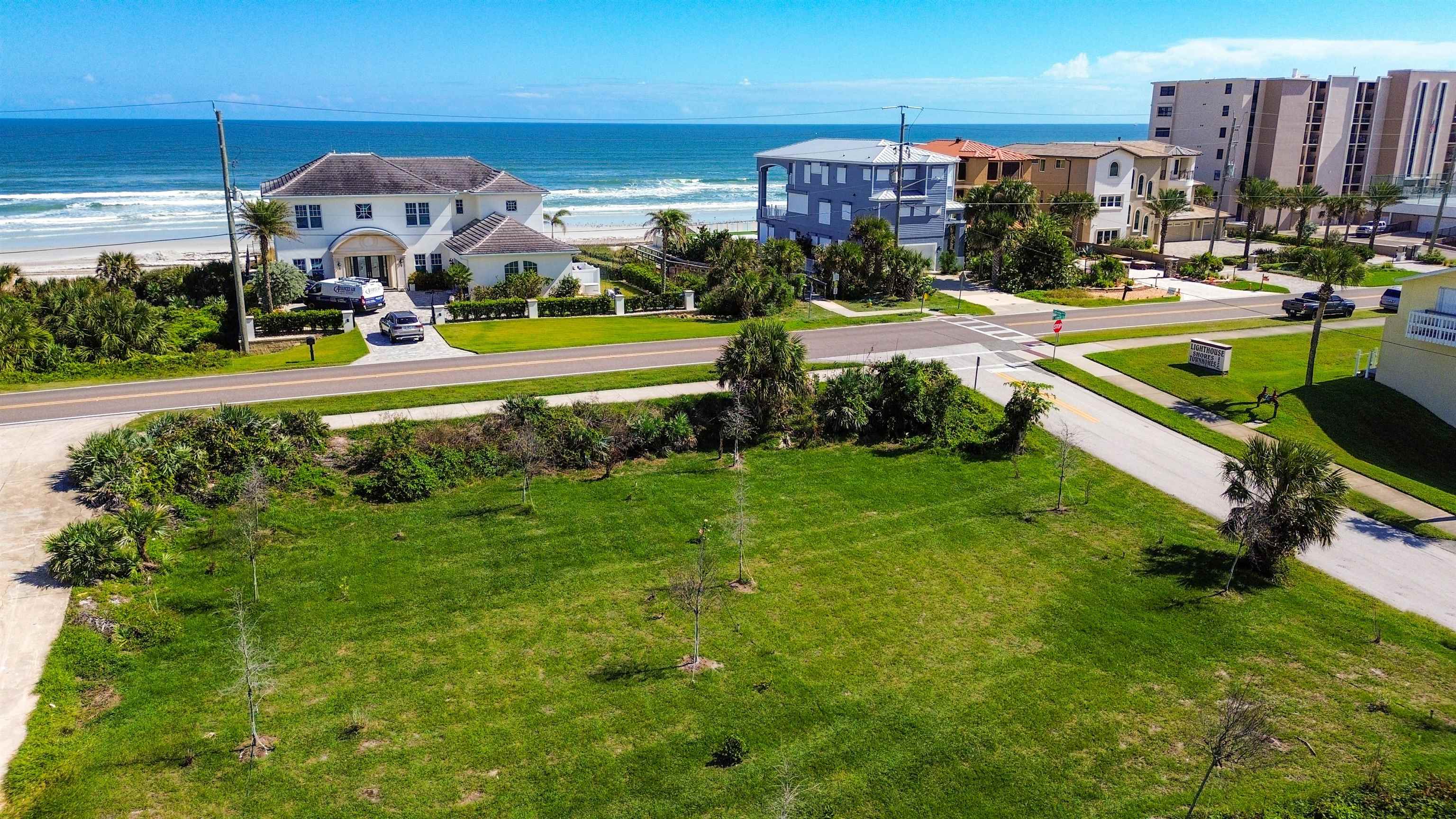 4736 South Atlantic Avenue Ponce Inlet, FL 32127 - Photo 29 of 32 a view of a swimming pool with lawn chairs and a big yard