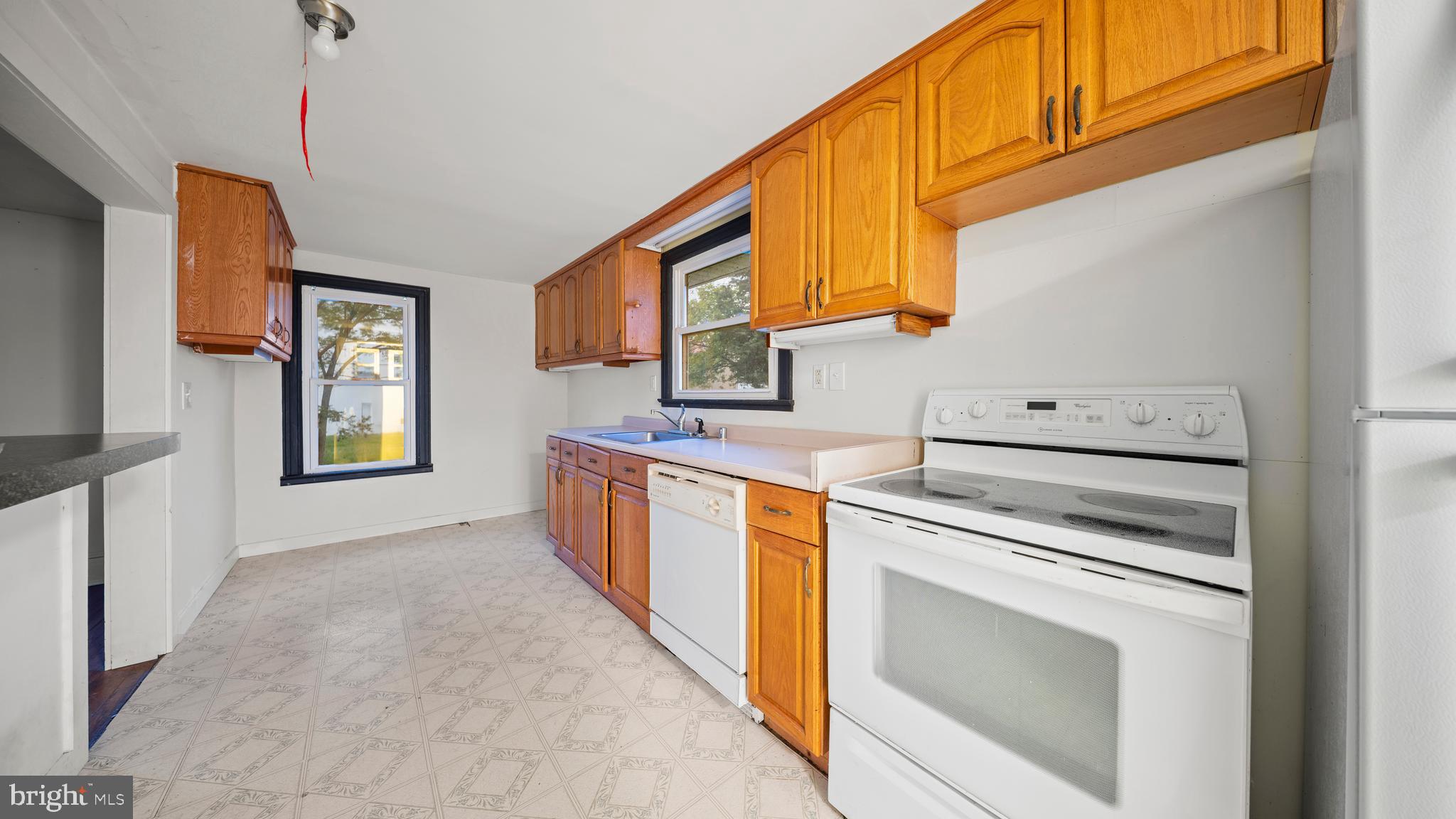2539 Old House Point Road Fishing Creek, MD 21634 - Photo 12 of 33 a kitchen with stainless steel appliances granite countertop a stove a sink and a microwave
