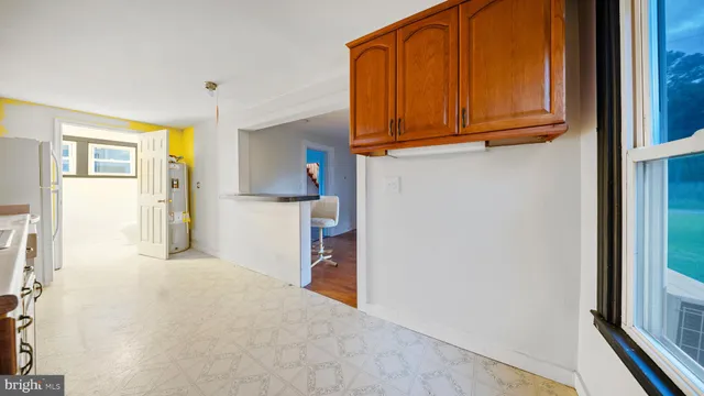 a view of a kitchen with wooden floor and cabinets