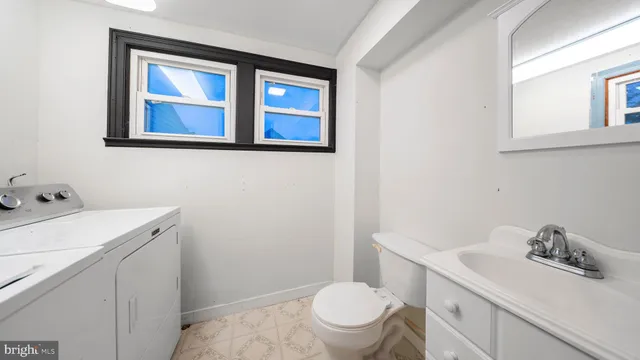 a bathroom with a sink toilet and vanity