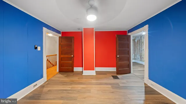 a view of empty room with wooden floor