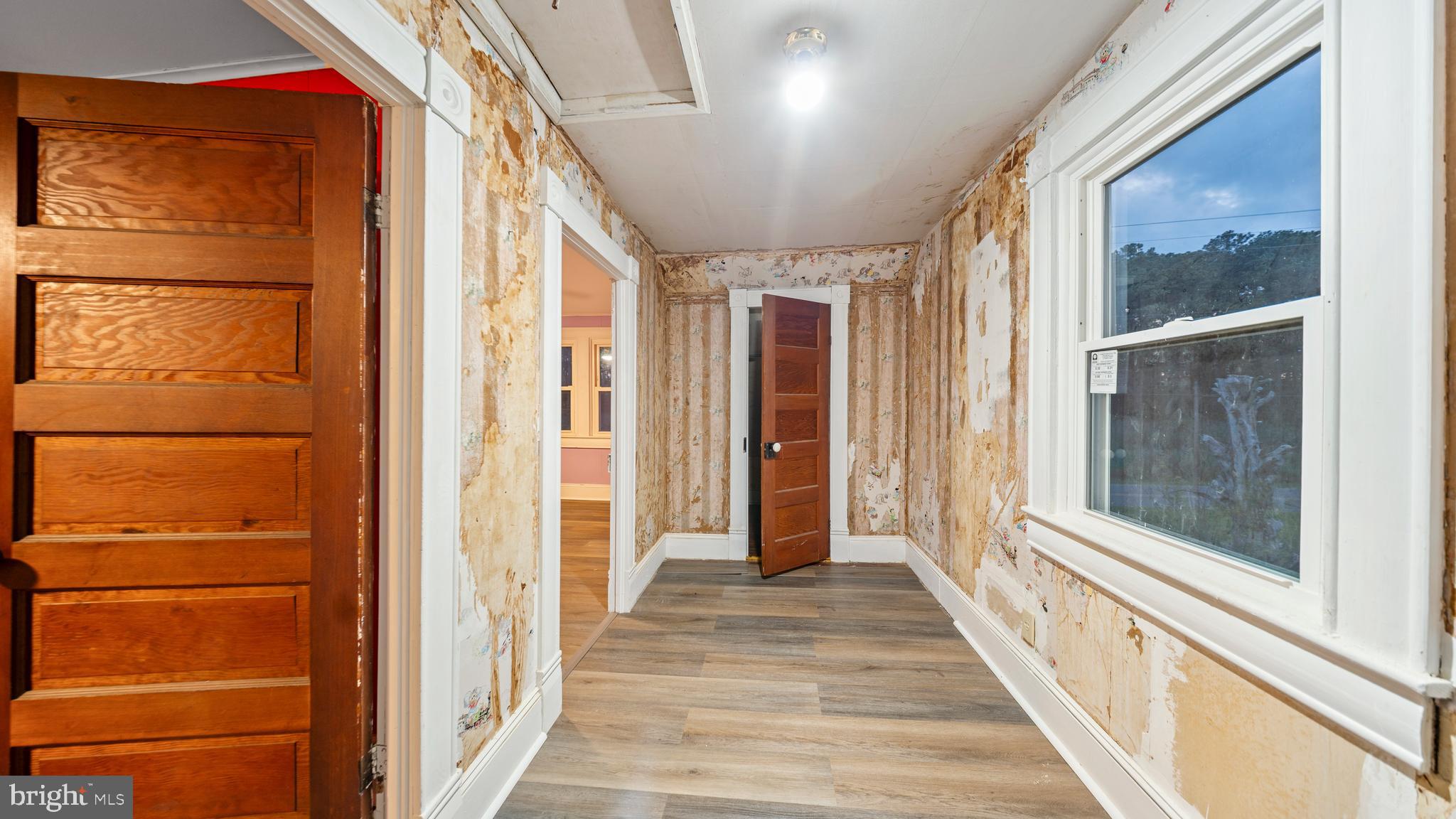 2539 Old House Point Road Fishing Creek, MD 21634 - Photo 24 of 33 a view of a hallway with wooden floor and windows