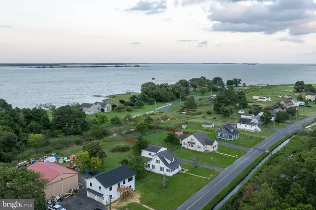 an aerial view of lake and residential houses with outdoor space