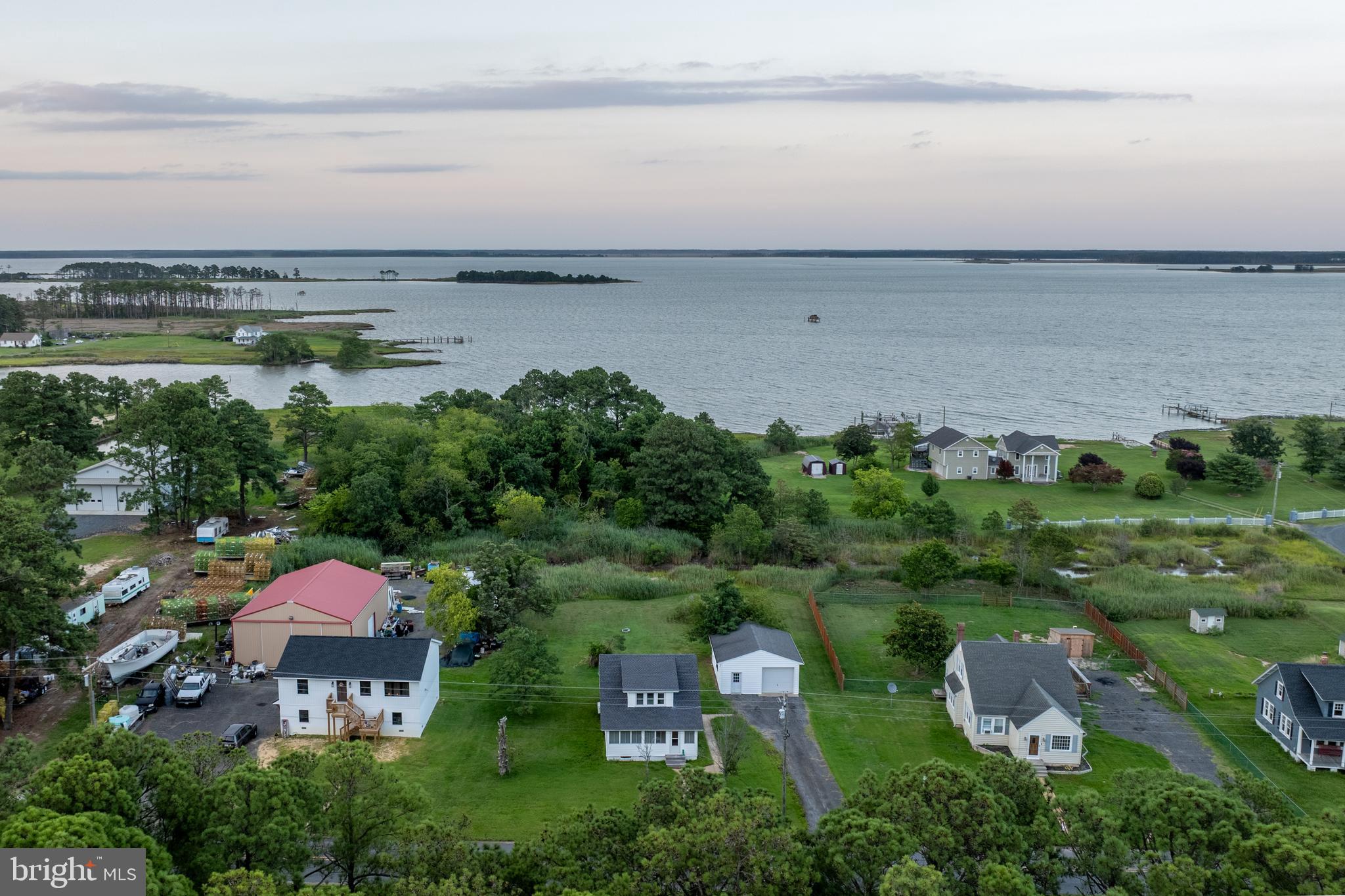 2539 Old House Point Road Fishing Creek, MD 21634 - Photo 4 of 33 an aerial view of a city with lots of residential buildings and ocean view in back