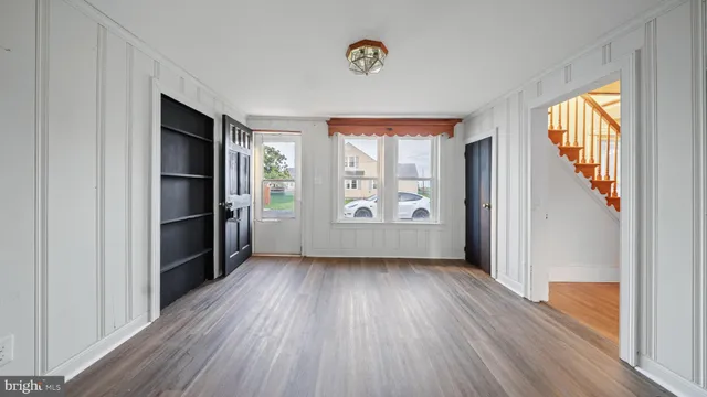 wooden floor in an empty room with a window