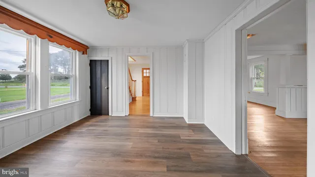 a view of a room with wooden floor and a window