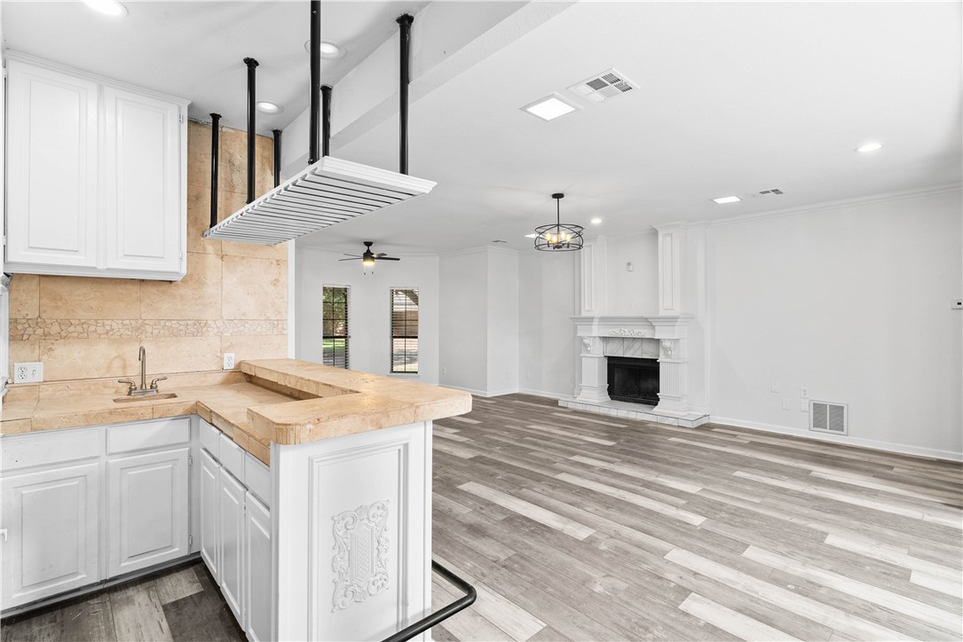 7009 Bevington Drive Corpus Christi, TX 78413 - Photo 12 of 34 a view of a kitchen with a sink and a fireplace