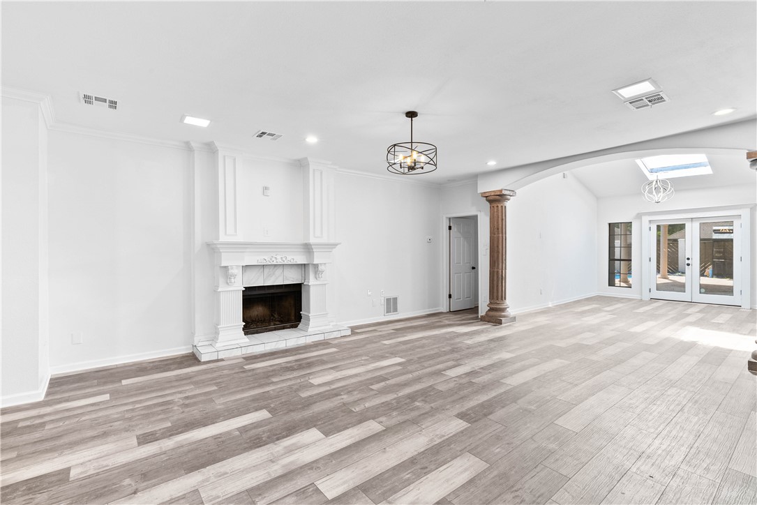 7009 Bevington Drive Corpus Christi, TX 78413 - Photo 13 of 34 a view of a livingroom with a fireplace a ceiling fan and windows