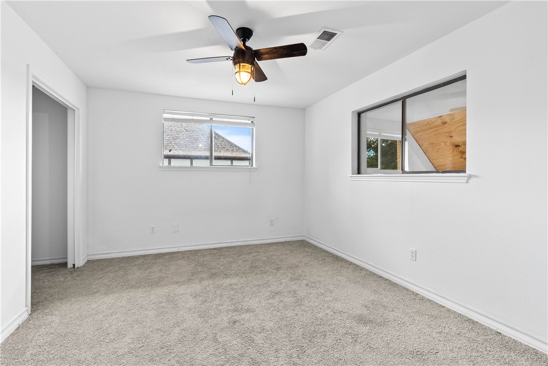 7009 Bevington Drive Corpus Christi, TX 78413 - Photo 29 of 34 an empty room with a window and a ceiling fan