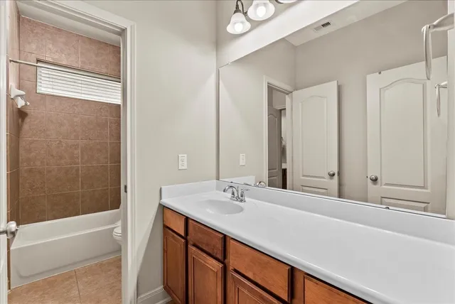 a bathroom with a sink toilet and a mirror