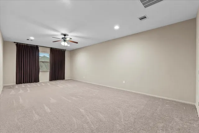 a view of a big room with a ceiling fan and chandelier fan