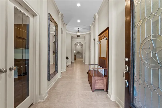 a view of a hallway to a livingroom and a hall with wooden floor