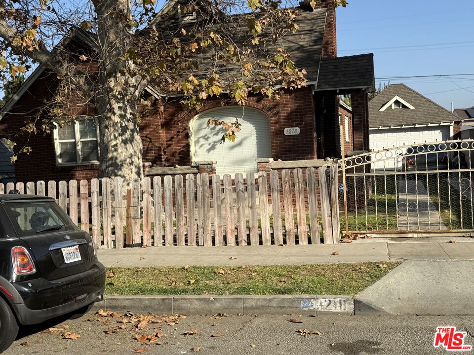 1218 North Spring Avenue Compton, CA 90221 - Photo 1 of 16 a view of a brick house with a large windows