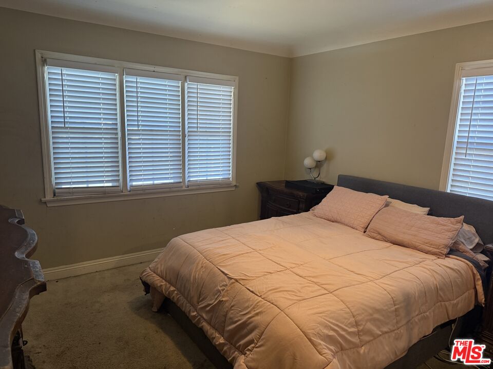 1218 North Spring Avenue Compton, CA 90221 - Photo 11 of 16 a bedroom with a bed and a window