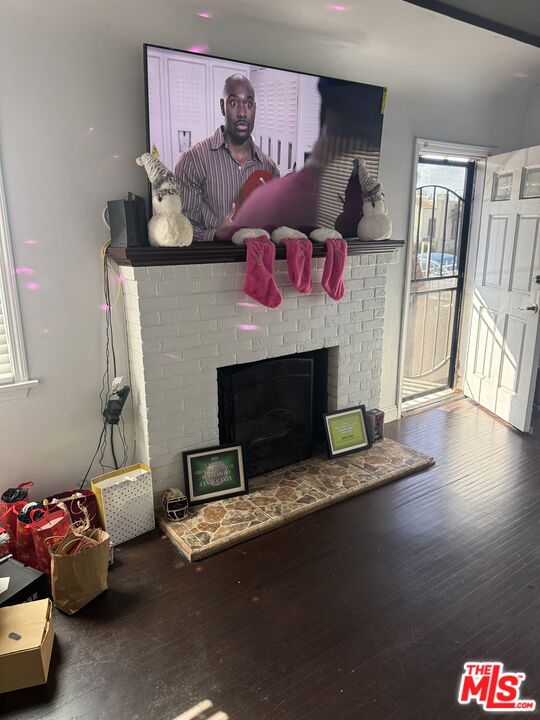 1218 North Spring Avenue Compton, CA 90221 - Photo 13 of 16 a living room with furniture and a fireplace