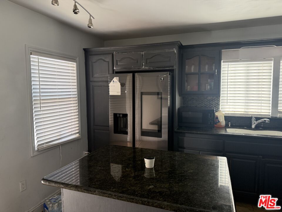 1218 North Spring Avenue Compton, CA 90221 - Photo 4 of 16 a kitchen with stainless steel appliances granite countertop a sink and a window