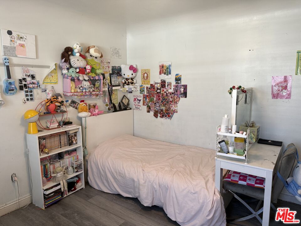 1218 North Spring Avenue Compton, CA 90221 - Photo 6 of 16 a bedroom with a bed and cabinets