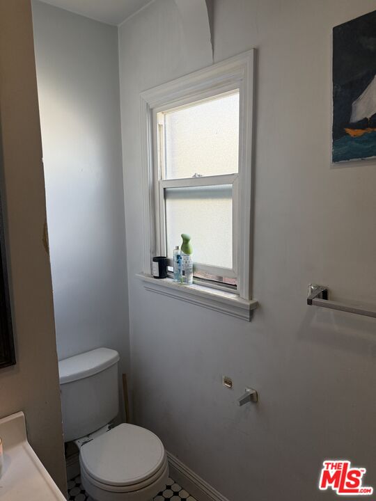 1218 North Spring Avenue Compton, CA 90221 - Photo 8 of 16 a white toilet sitting next to a window in a bathroom