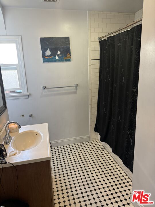 1218 North Spring Avenue Compton, CA 90221 - Photo 9 of 16 a bedroom with a bed and a window