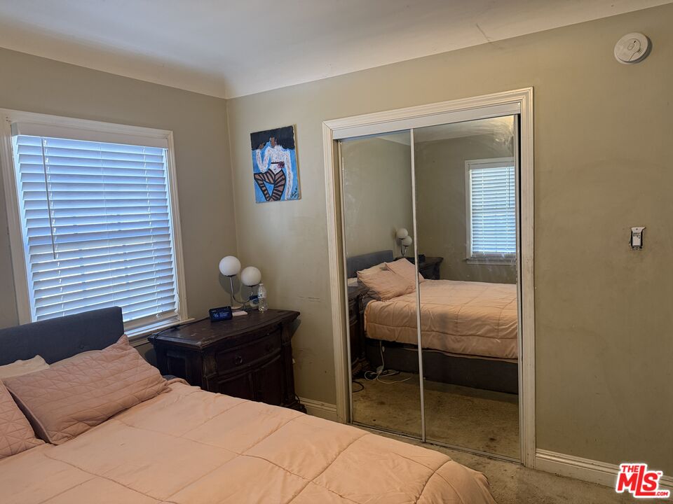 1218 North Spring Avenue Compton, CA 90221 - Photo 10 of 16 a bedroom with a bed and a lamp