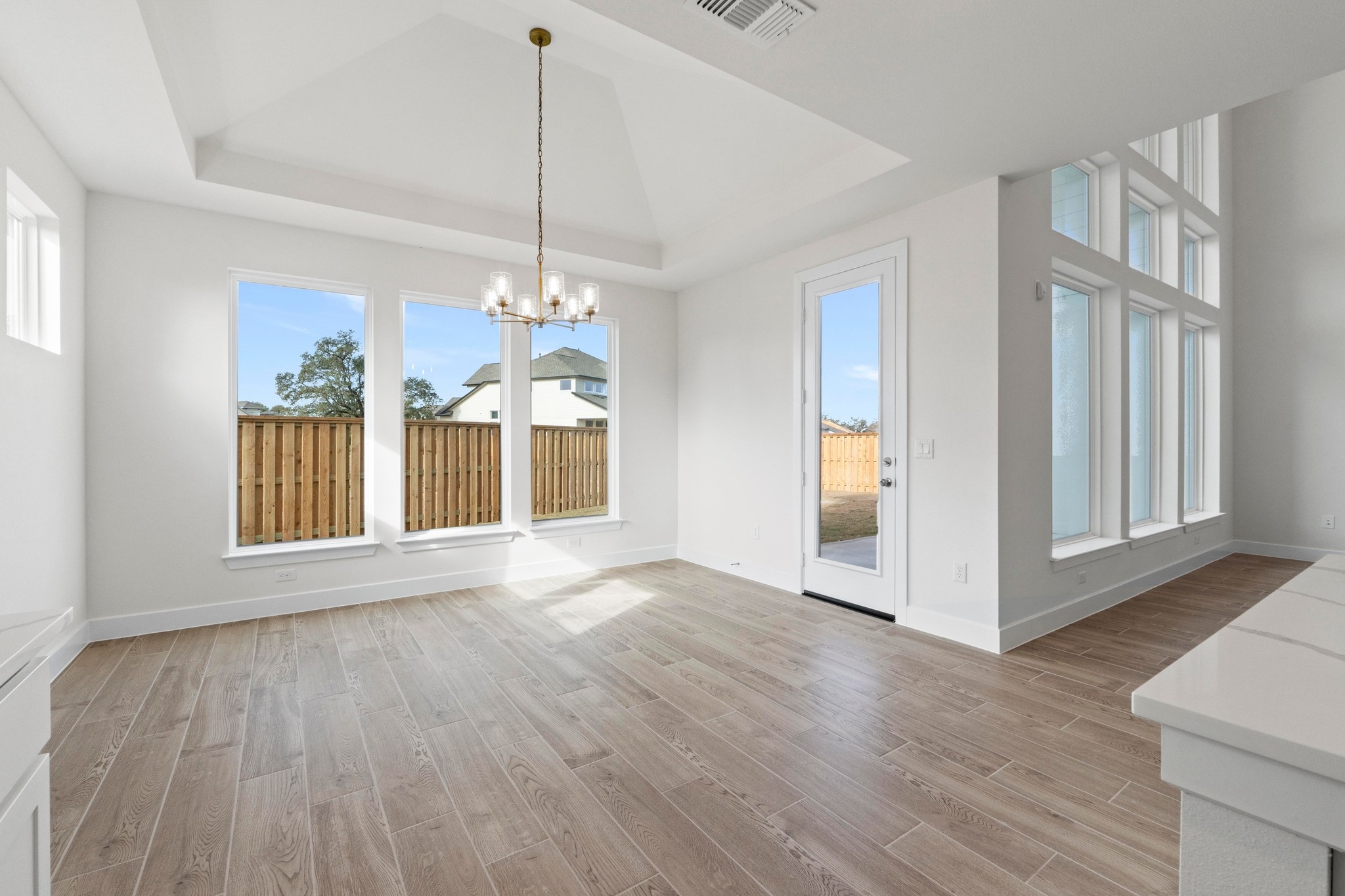 604 Lightstone Drive Georgetown, TX 78633 - Photo 8 of 39 a view of an empty room with wooden floor and a window