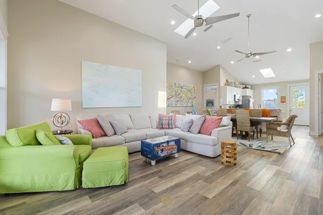 a bedroom with a large bed a flat tv screen and a dresser