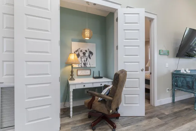 a bedroom with furniture and a flat screen tv