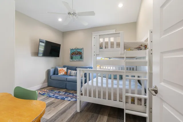 a view of a balcony with wooden floor & fence