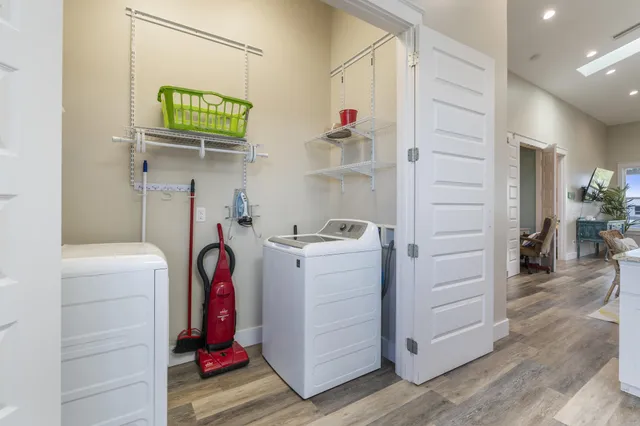 an aerial view of residential houses with outdoor space and ocean view