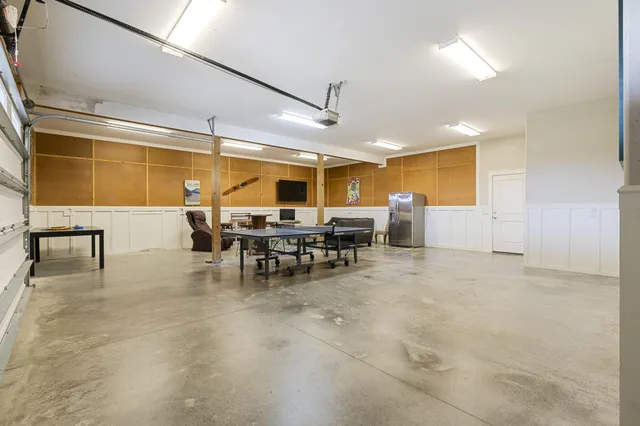 an aerial view of residential houses with outdoor space and river