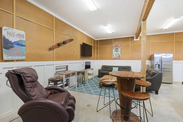 an aerial view of residential houses with outdoor space and ocean view