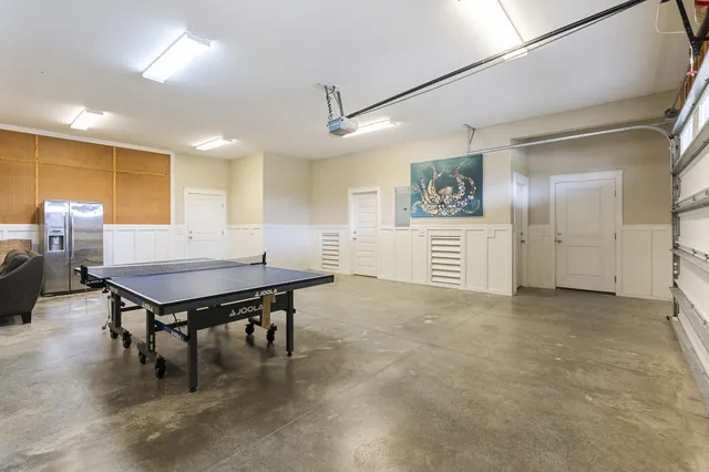 an aerial view of a house with a yard and a large pool