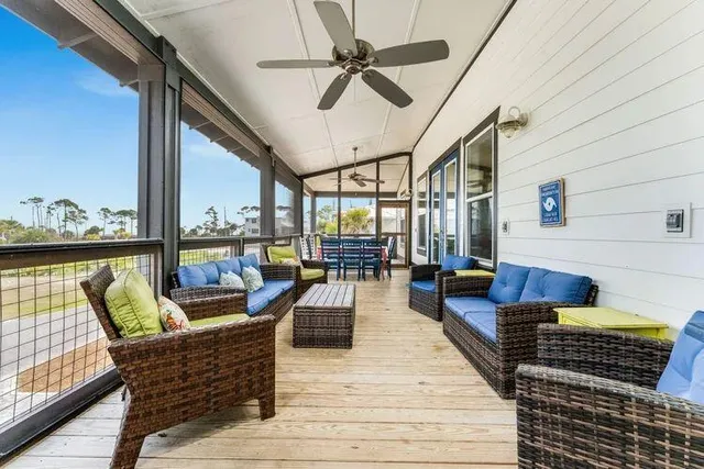 a view of a city from a dining room with furniture and wooden floor