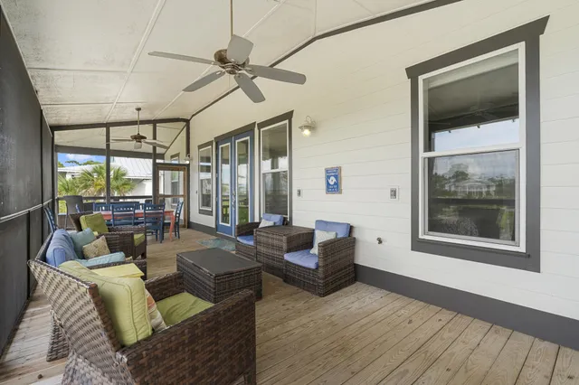 a view of a balcony with table and chairs and potted plants