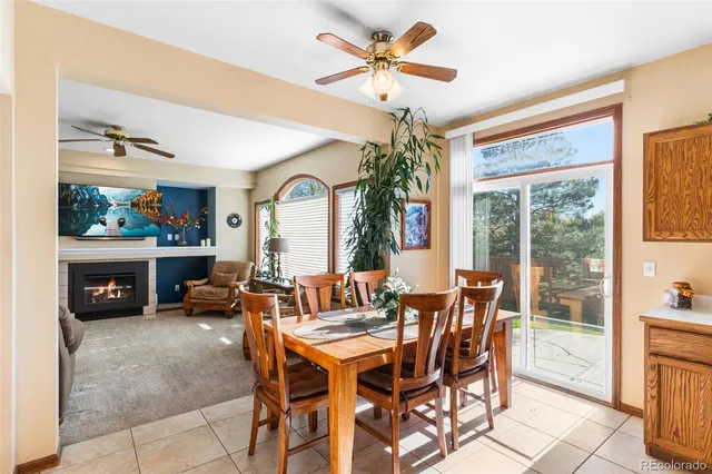 a dining room with furniture a chandelier and a flat screen tv