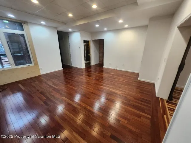 a kitchen with wooden floors wooden cabinets microwave and cabinets