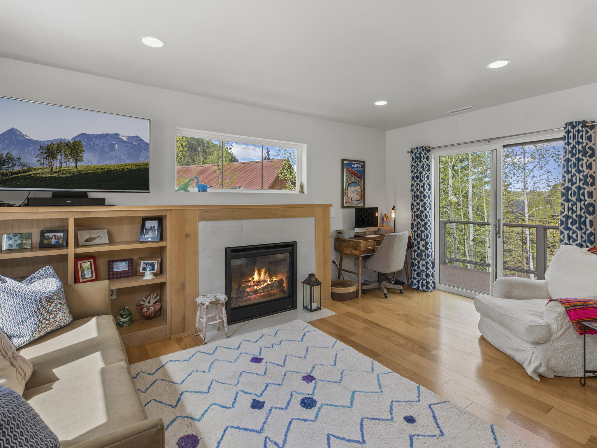 165 Alexander Overlook Telluride, CO 81435 - Photo 1 of 27 a living room with furniture a flat screen tv and a fireplace