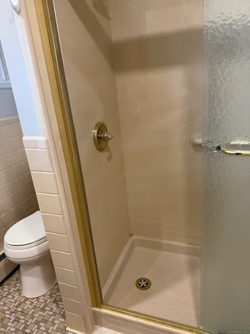 a bathroom with a tub and toilet