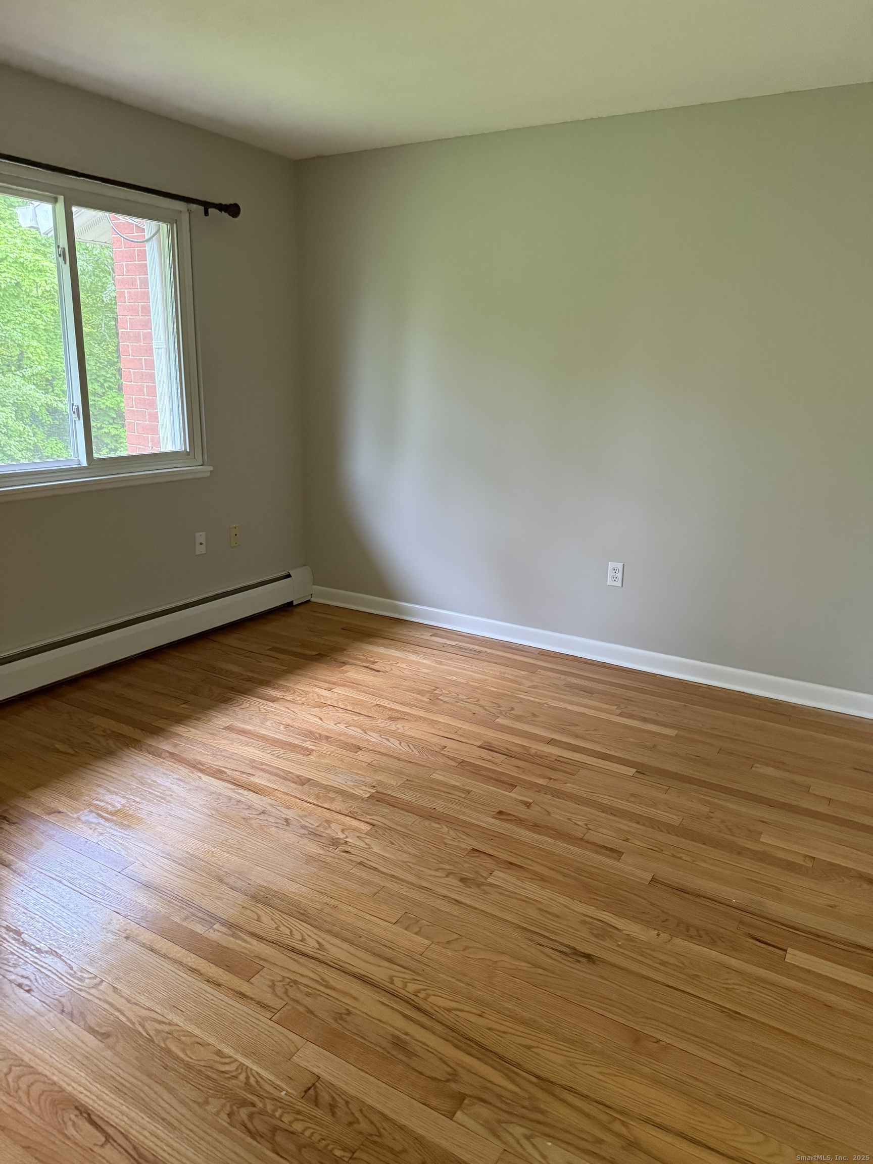 240 Centerbrook Road, Unit 240 Hamden, CT 06518 - Photo 14 of 26 a view of an empty room with wooden floor and a window