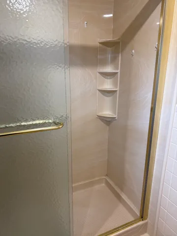 a bathroom with a glass shower door