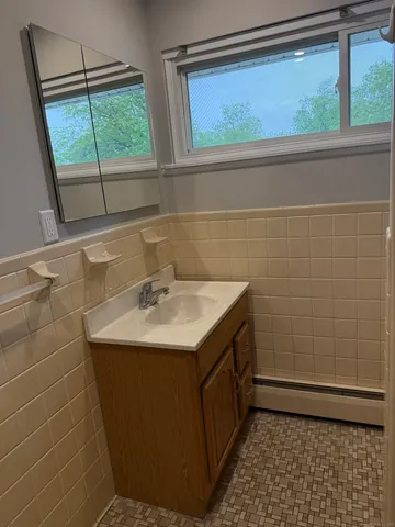 a bathroom with a sink a toilet and a shower