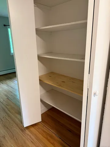 a view of walk in closet with empty racks
