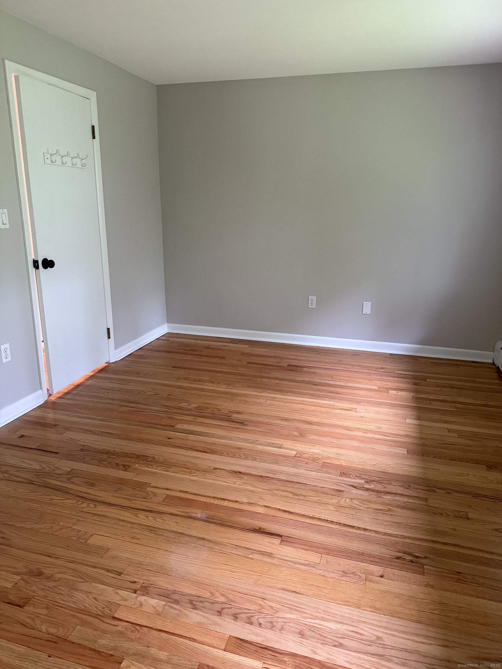 240 Centerbrook Road, Unit 240 Hamden, CT 06518 - Photo 19 of 26 a view of an empty room with wooden floor and white walls