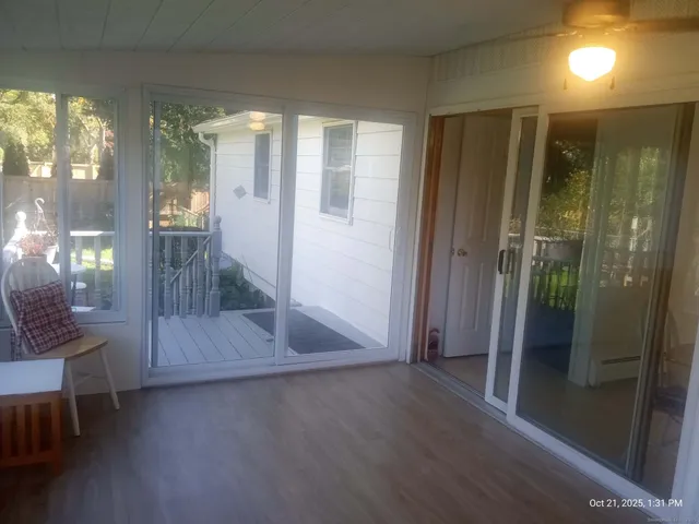 a view of entryway with wooden floor and glass door