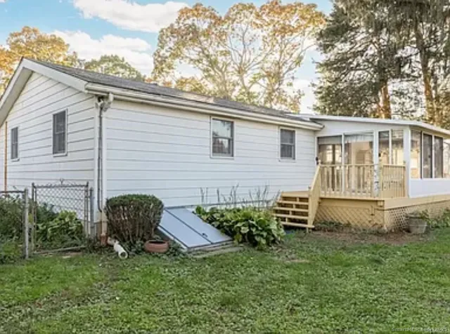 a backyard of a house with table and chairs