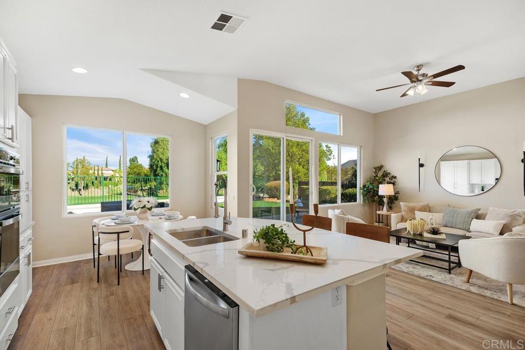 46056 Paseo Gallante Temecula, CA 92592 - Photo 12 of 41 a view of a kitchen living room and balcony with wooden floor