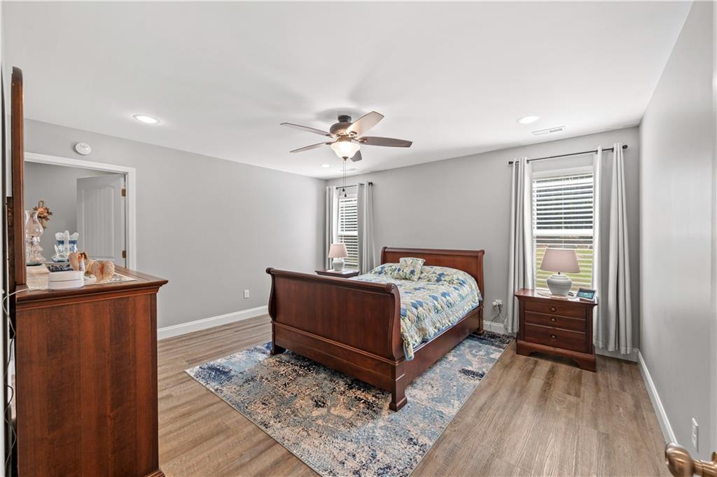 611 Bell Loop Chatsworth, GA 30705 - Photo 21 of 42 a bedroom with a bed and a chandelier