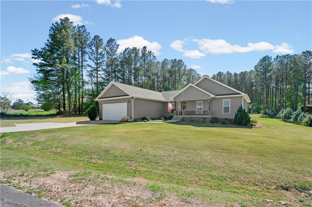 611 Bell Loop Chatsworth, GA 30705 - Photo 4 of 42 a front view of a house with yard and green space