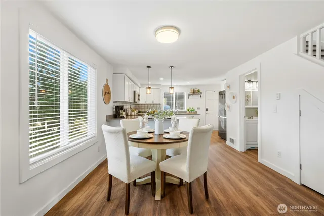 a dining room with furniture and wooden floor