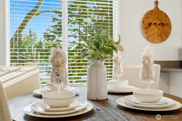 a vase of flowers sitting next to a window